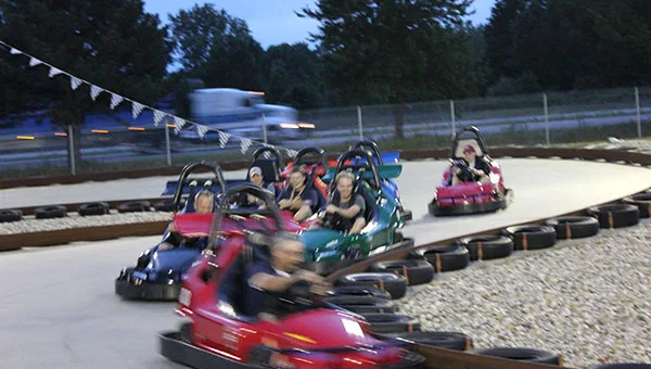 Go-kart racing on the banked track at Hidden Pointe