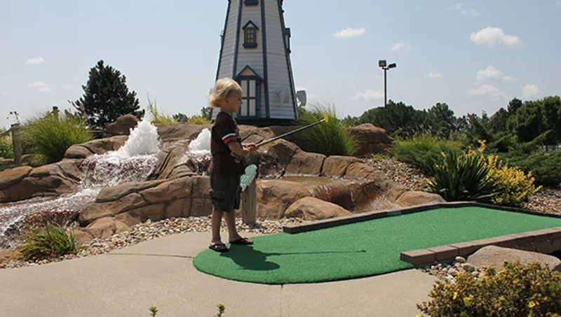 Families enjoying miniature golf at Hidden Pointe Fun Park